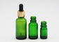 Garrafas do conta-gotas do óleo essencial de cor verde dos cuidados com a pele com conta-gotas de alumínio