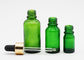 Garrafas do conta-gotas do óleo essencial de cor verde dos cuidados com a pele com conta-gotas de alumínio